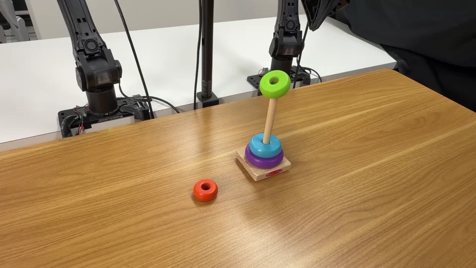 Real recovery of the pictured failure: the gripper presses the caught ring onto the stack